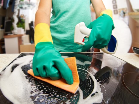 Local cleaner carrying out routine kitchen and bathroom cleaning in Catford